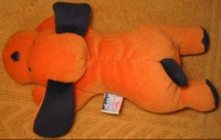 doudou hochet chien orange et noir couché - marque Sucre d'orge