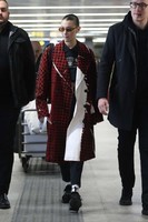 bella-hadid-wears-in-a-red-checkered-pvc-coat-at-milan-airport-in-milan-1-683x1024