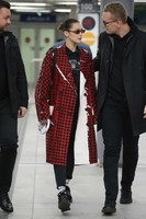 bella-hadid-wears-in-a-red-checkered-pvc-coat-at-milan-airport-in-milan-2