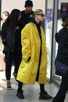 hailey-baldwin-bieber-stands-out-in-a-bright-yellow-long-coat-as-she-arrives-on-an-early-flight-at-t