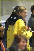 hailey-bieber-sports-bright-yellow-coat-for-flight-to-paris-04