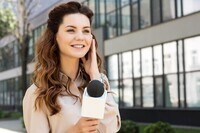 stock-photo-beautiful-anchorwoman-taking-interview-microphone (1)