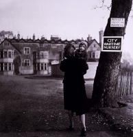 toni_frissell__mother_carrying_child_outside_wartime_nursery__ca._1945