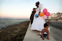 Bride with children. El Malecon, Havana