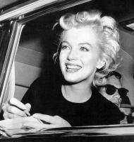 Marilyn Monroe singing an autograph on her birthday 1956