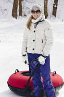 24385579-Woman-having-fun-going-snow-tubing-on-a-winter-day-Stock-Photo