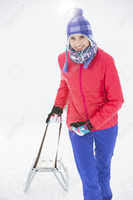 33861874-Beautiful-young-woman-pulling-sled-Stock-Photo