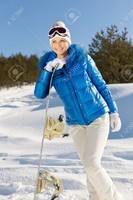 12645995-a-beautiful-young-girl-with-a-snowboard-in-her-hand-standing-on-a-hillside-Stock-Photo