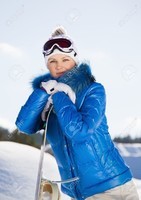 17364853-Beautiful-young-woman-standing-with-snowboard-in-her-hand-sunny-winter-day-Stock-Photo