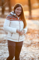 36598563-Young-smiling-woman-stands-in-the-winter-park-in-sunset-light-of-sunset-sun-Stock-Photo