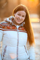 36598896-Portrait-of-attractive-smiling-woan-in-white-down-jacket-in-the-sunlight-Stock-Photo