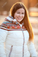 36598541-Portrait-of-beautiful-smiling-woan-in-white-down-jacket-in-the-sunlight-Stock-Photo