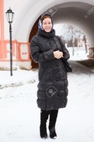12022272-Russian-woman-in-winter-clothes-against-Orthodox-monastery-building-Pilgrimage-Stock-Photo