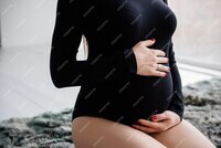 femme-enceinte-body-noir-tenant-son-ventre_102037-1638