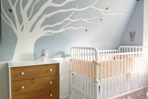 Nursery-room-for-low-budget-with-white-baby-crib-and-orange-fabric-accent-plus-dry-tree-pattern-on-w