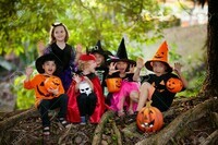 129956240-child-in-halloween-costume-mixed-race-asian-and-caucasian-kids-trick-or-treat-on-suburban-