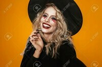 112483896-portrait-of-blonde-scary-woman-witch-in-black-hat-looking-camera-and-smiling-isolated-over