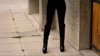 Femme Fatale In a Black Latex Catsuit